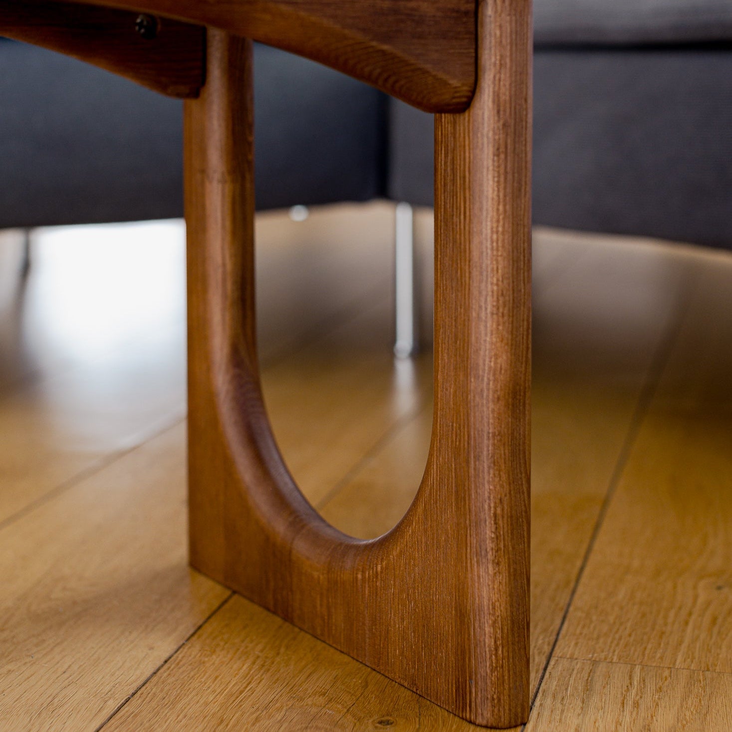 Wooden coffee table with a blurred sofa in the background