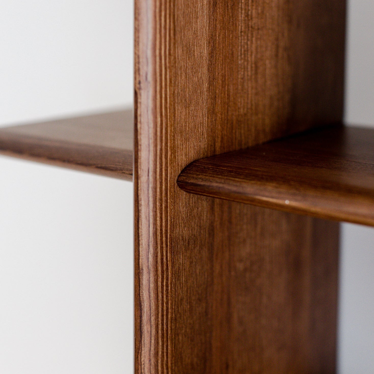 Close-up of a wooden shelf with a white background